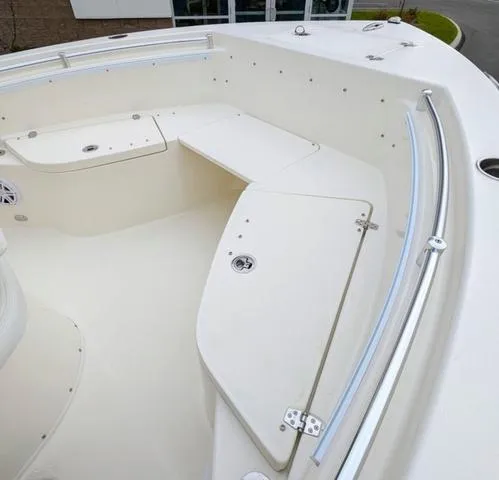 Slide: The Image of 2025 Cobia 220 CC boat with blue T-top and white console. - 38