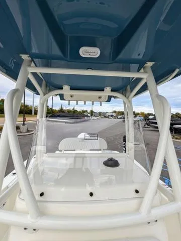 Slide: The Image of 2025 Cobia 220 CC boat interior, white deck and seating area. - 39
