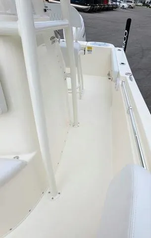 Slide: The Image of Cobia 220 CC 2025 boat interior with drainage system and warning label. - 40