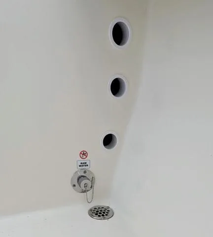 Slide: The Image of 2025 Cobia 220 CC boat interior with drainage system and clean white surface. - 41