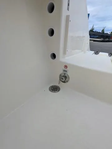 Slide: The Image of 2025 Cobia 220 CC boat interior with seating and cup holders. - 42