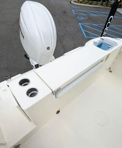 Slide: The Image of 2025 Cobia 220 CC boat battery compartment with wiring and connections. - 44