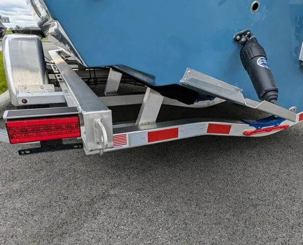 Slide: The Image of 2025 Cobia 220 CC boat stern with ladder and motor detail. - 8