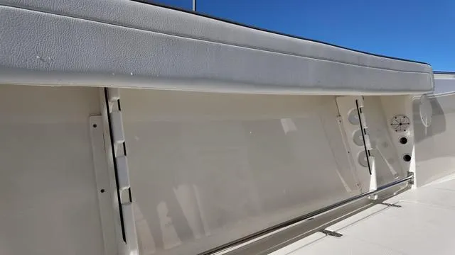 Slide: The Image of 2025 Cobia 265 CC boat interior detail with storage compartments. - 14