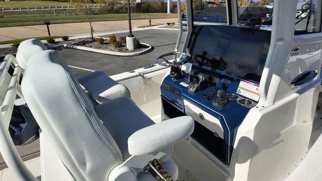 Slide: The Image of 2025 Cobia 265 CC boat cockpit with modern controls and seating. - 18