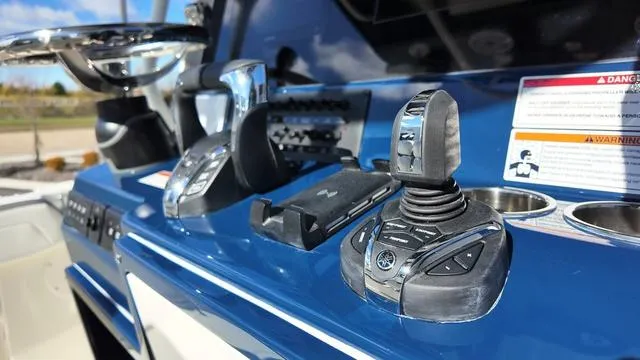 Slide: The Image of Close-up of 2025 Cobia 265 CC boat controls and dashboard. - 20