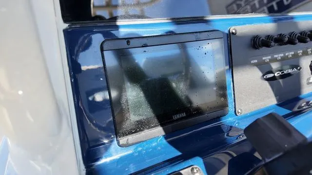 Slide: The Image of 2025 Cobia 265 CC dashboard with Yamaha display and controls. - 23