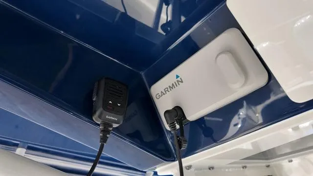 Slide: The Image of Garmin equipment installed on 2025 Cobia 265 CC boat, featuring blue and white interior. - 25