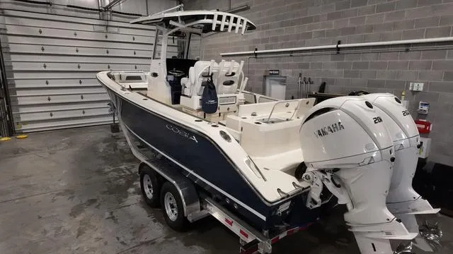 Slide: The Image of 2025 Cobia 265 CC boat with Yamaha engines in a garage. - 3