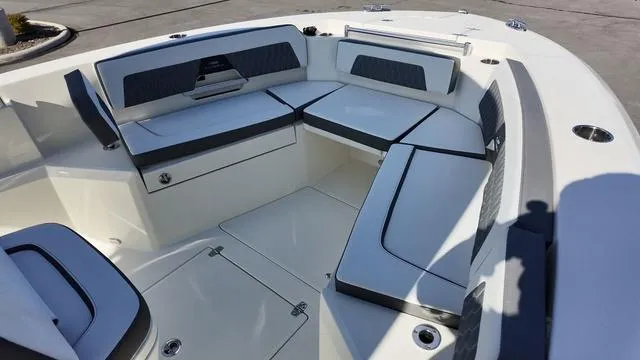 Slide: The Image of 2025 Cobia 265 CC boat interior with cushioned seating and storage compartments. - 31