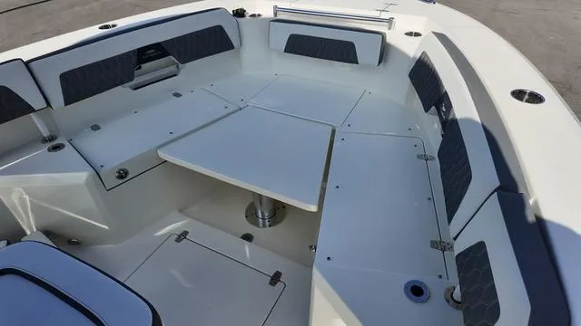 Slide: The Image of 2025 Cobia 265 CC boat interior with seating and table. - 33