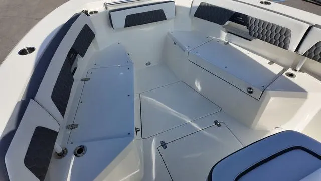 Slide: The Image of 2025 Cobia 265 CC boat interior with cushioned seating and storage compartments. - 34