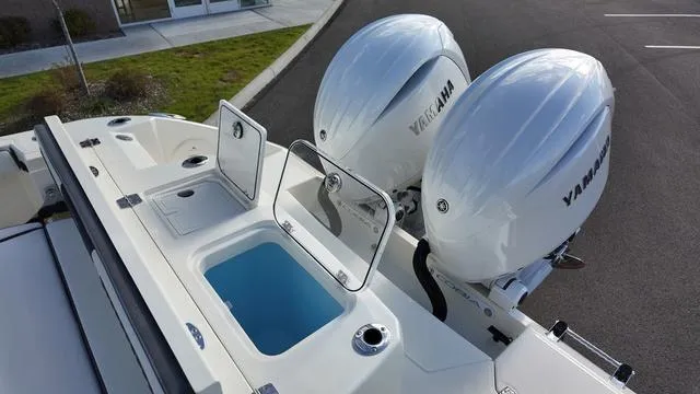 Slide: The Image of 2025 Cobia 265 CC boat with dual Yamaha outboard engines and open storage compartments. - 5