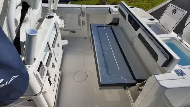 Slide: The Image of 2025 Cobia 265 CC boat interior with seating and storage compartments. - 9