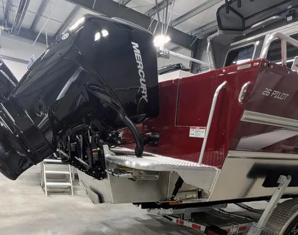 Slide: The Image of 2025 Thunder Jet Pilot 26' boat with Mercury outboard motor in a garage setting. - 16