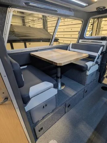 Slide: The Image of Interior of 2025 Thunder Jet Pilot 26' boat with seating and wooden table. - 22