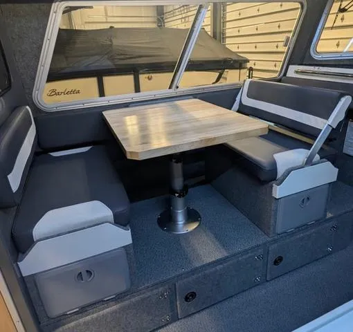 Slide: The Image of Interior of 2025 Thunder Jet Pilot 26' boat with dining area and seating. - 23