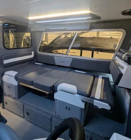 Slide: The Image of Interior of 2025 Thunder Jet Pilot 26' boat with modern seating and sleek design. - 27