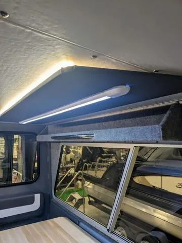 Slide: The Image of Interior of 2025 Thunder Jet Pilot 26' boat with modern lighting and window view. - 31