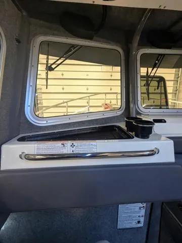 Slide: The Image of Interior of 2025 Thunder Jet Pilot 26' boat with windows and storage area. - 33