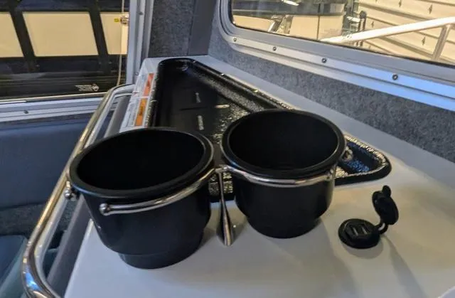 Slide: The Image of Interior of 2025 Thunder Jet Pilot 26' boat with cup holders and storage area. - 34