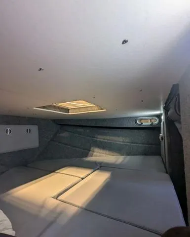 Slide: The Image of Interior cabin of 2025 Thunder Jet Pilot 26' boat, featuring cushioned seating and overhead lighting. - 36