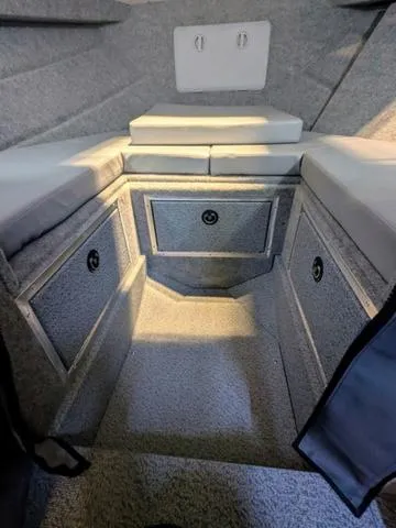 Slide: The Image of Interior cabin of 2025 Thunder Jet Pilot 26' boat with cushioned seating and storage. - 38