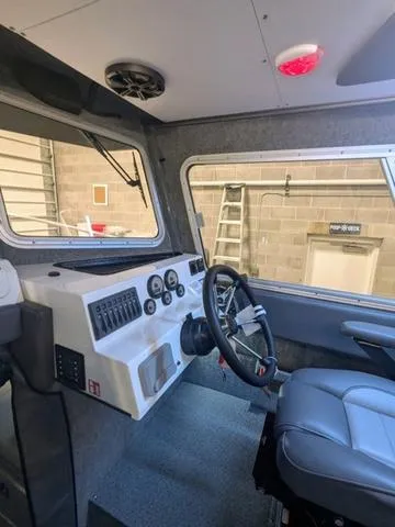Slide: The Image of Interior of 2025 Thunder Jet Pilot 26' boat with modern dashboard and steering wheel. - 41