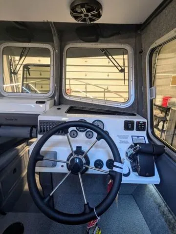 Slide: The Image of Interior of 2025 Thunder Jet Pilot 26' boat with steering wheel and control panel. - 42