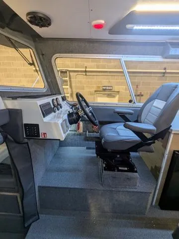 Slide: The Image of Interior of 2025 Thunder Jet Pilot 26' boat with modern helm and seating. - 48