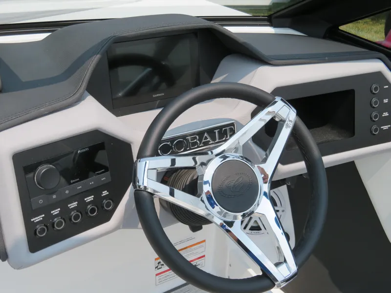 Slide: The Image of 2025 Cobalt CS23 boat dashboard with modern steering wheel and control panel. - 11