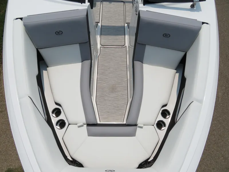 Slide: The Image of 2025 Cobalt CS23 boat interior with gray and white seating and cup holders. - 16
