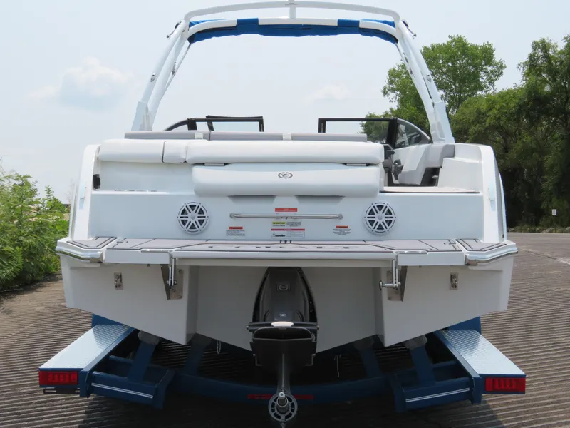 Slide: The Image of 2025 Cobalt CS23 boat on trailer, rear view, showcasing sleek design and modern features. - 4