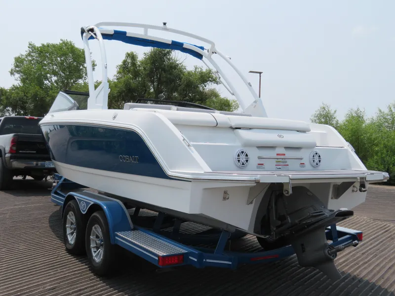 Slide: The Image of 2025 Cobalt CS23 boat on trailer, rear view, blue and white design. - 5