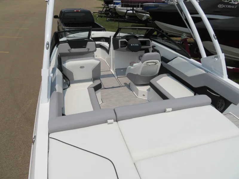 Slide: The Image of 2025 Cobalt CS23 boat interior with modern seating and steering console. - 6