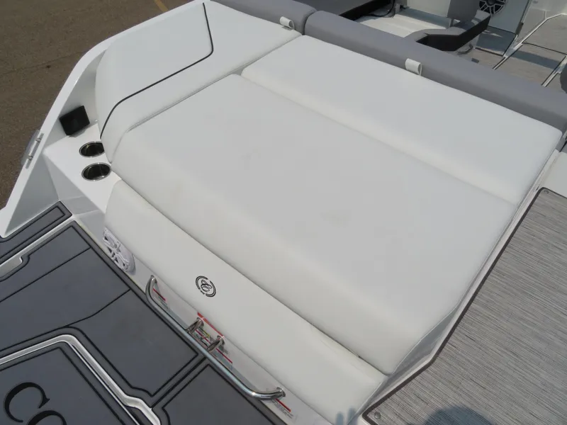 Slide: The Image of 2025 Cobalt CS23 boat with white cushioned seating and sleek design. - 7