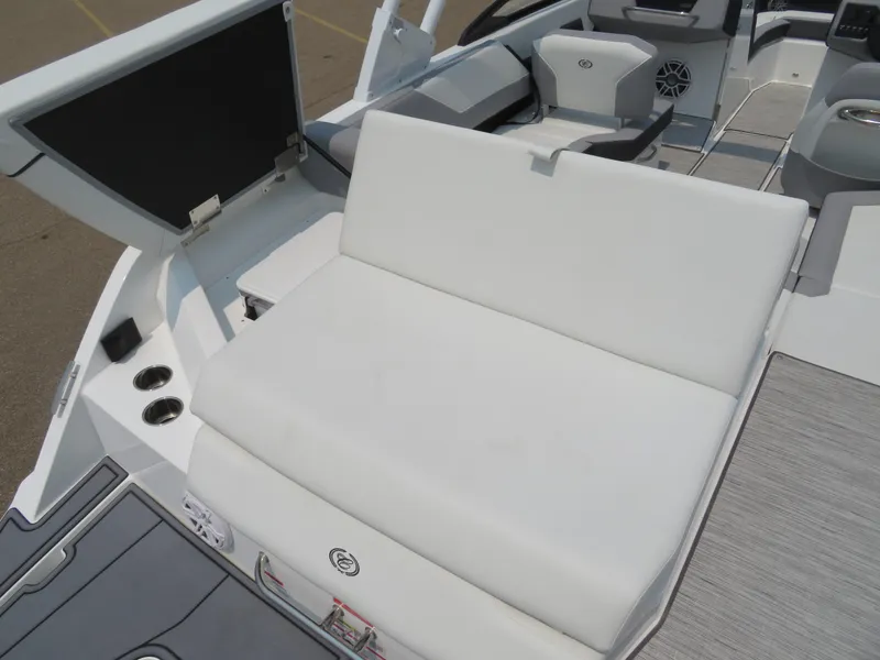 Slide: The Image of 2025 Cobalt CS23 boat interior with white seating and storage compartment. - 8
