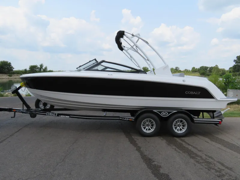 Slide: The Image of 2025 Cobalt CS22 boat on trailer, sleek design, parked outdoors. - 1