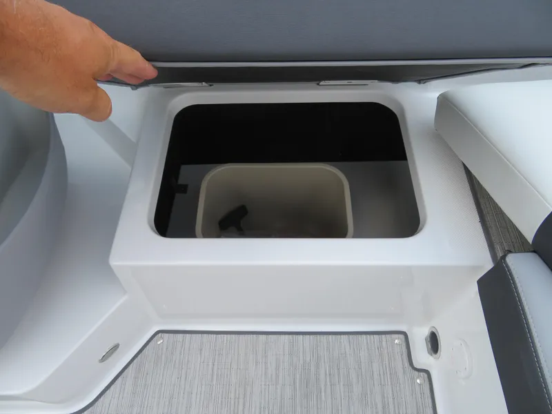 Slide: The Image of 2025 Cobalt CS22 boat storage compartment with open lid, showcasing interior space. - 13