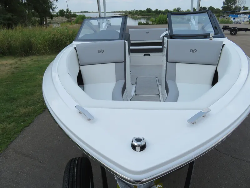 Slide: The Image of 2025 Cobalt CS22 boat with sleek white interior and dual windshields, parked outdoors. - 15