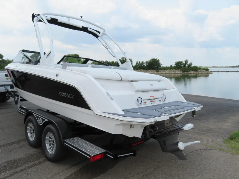 Slide: The Image of 2025 Cobalt CS22 boat on trailer by a lake, ready for launch. - 3