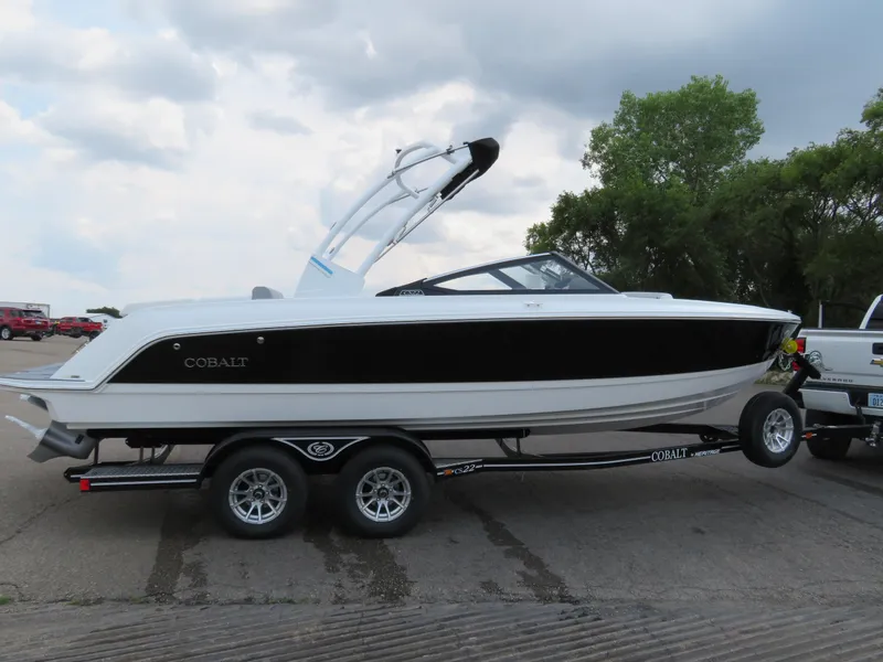 Slide: The Image of 2025 Cobalt CS22 boat on trailer, parked outdoors under cloudy sky. - 5