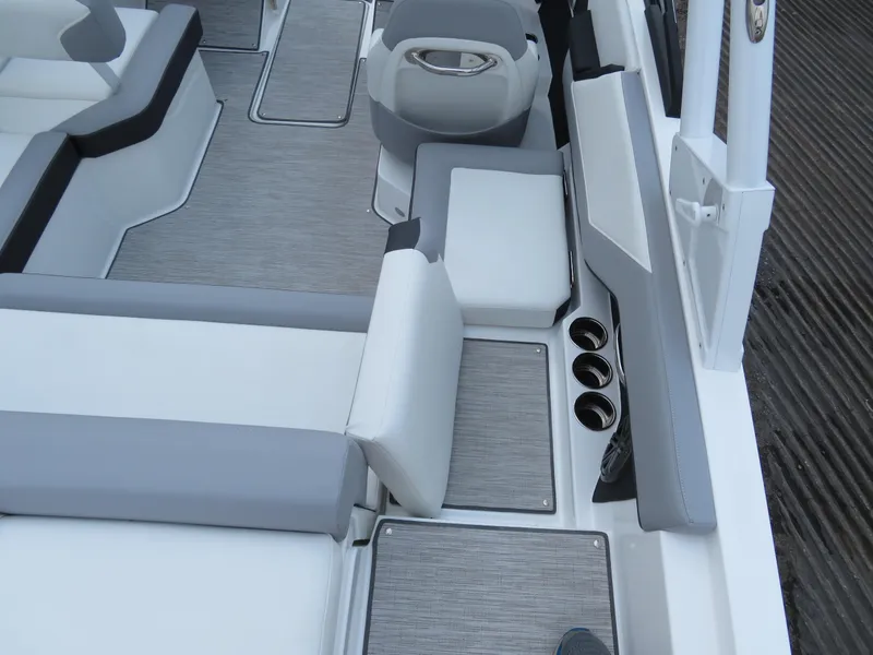 Slide: The Image of 2025 Cobalt CS22 boat interior with gray seating and cup holders. - 8