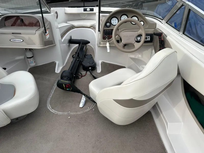 Slide: The Image of 2003 Four Winns Freedom 180F/S boat interior with steering wheel and seating. - 10