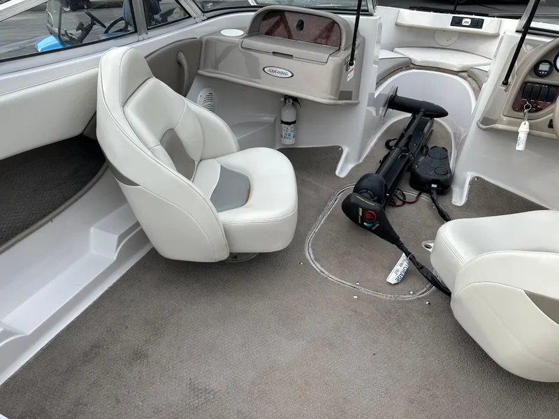 Slide: The Image of 2003 Four Winns Freedom 180F/S boat interior with white seating and steering console. - 11