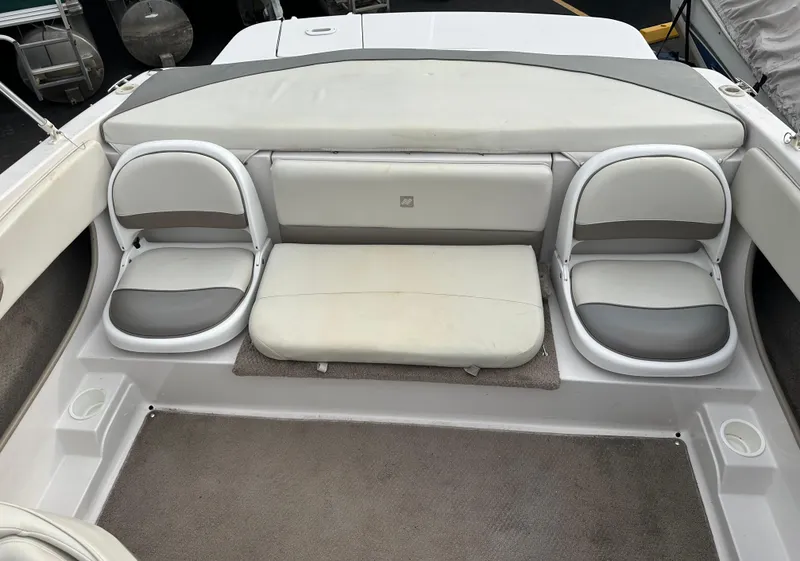 Slide: The Image of 2003 Four Winns Freedom 180F/S boat interior with cushioned seating and carpeted floor. - 12