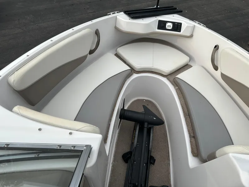 Slide: The Image of 2003 Four Winns Freedom 180F/S boat interior with cushioned seating and storage. - 21