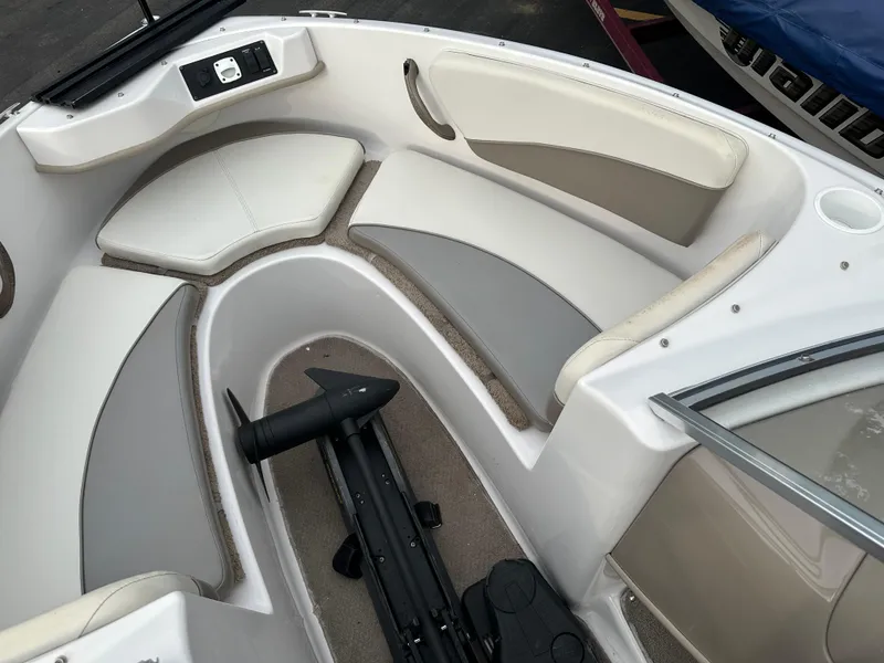 Slide: The Image of 2003 Four Winns Freedom 180F/S boat interior with cushioned seating and storage. - 22