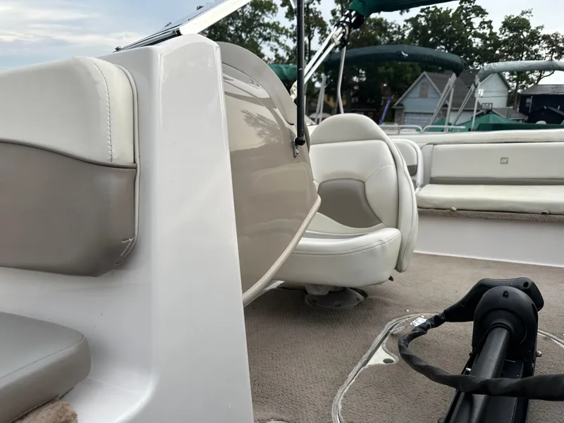 Slide: The Image of 2003 Four Winns Freedom 180F/S boat interior with white seating and steering wheel. - 23