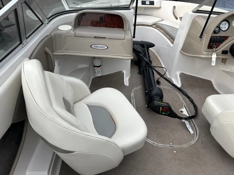 Slide: The Image of 2003 Four Winns Freedom 180F/S boat interior with beige seating and carpeted flooring. - 26